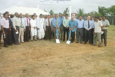 CEO of Neal and Massy Deo Persaud (at right with spade in hand)  and Prime Minister Samuel Hinds (also with spade) flanked by company officials and other stakeholders at the sod turning ceremony for the new Neal and Massy distribution warehouse at Montrose.