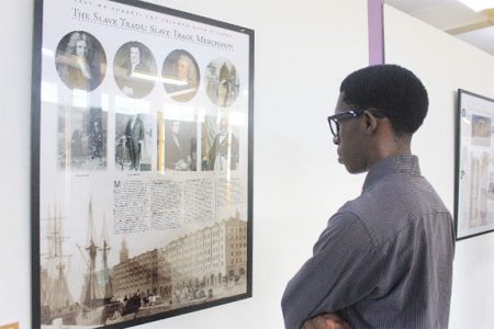 A young man views one of the many displays at the UNESCO mobile slavery exhibition that opened yesterday at the National Museum. (Photo by Arian Browne)