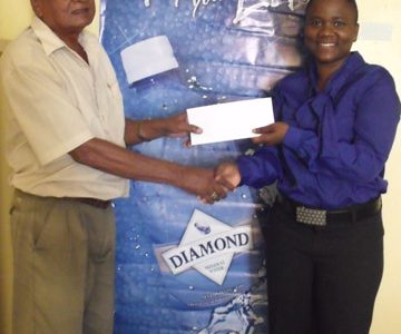 National Cycling Coach, Hassan Mohamed collects the sponsorship cheque from DDL Sales Manager, Alexis Langhorne.