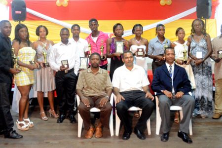 The awardees (standing) with the Minster of Sport, Dr. Frank Anthony (seated center), president of the Athletics Association of Guyana (AAG) Aubrey Hutson (right) and Guyana Olympic Association representative Charles Corbin (left) after the conclusion of the Annual Awards Ceremony at YMCA, Thomas Lands last Friday evening.