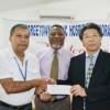 Japan’s Ambassador to Guyana His Excellency Yoshimasa Tezuka hands over the cheque to Georgetown Public Hospital Corporation’s Chief Executive Officer Michael Khan in the presence of Prime Minister Samuel Hinds. (Government Information Agency photo)