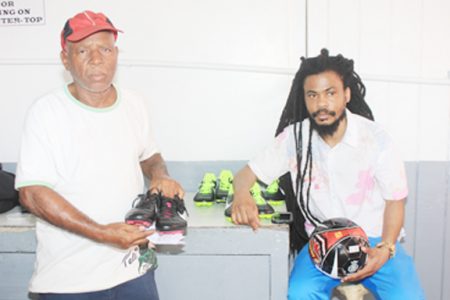 Camptown Football Classic host Gordon Van Rossum with tournament PRO Johnny ‘Overseas’ Barnwell displaying equipment to be given to players.