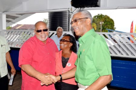 President Donald Ramotar (left) greets Opposition leader David Granger at the Regatta. (GINA photo)
