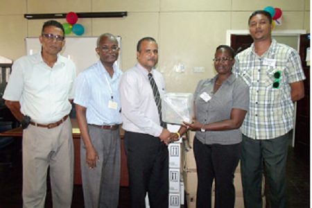 Third from left - Kent Vincent, head of Food For The Poor (Guyana) hands over the donation to Nurse Faye Jones, Ministry of Health.