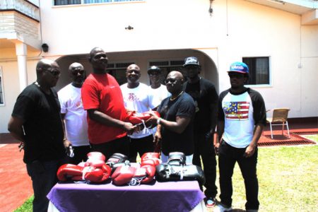 GBA’s Tournament Director, Terrence Poole, (left) receiving a quantity of boxing gloves from CEO of Briso Promotions, Seon Bristol yesterday. (Aubrey Crawford photo)
