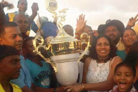 Owners of Score’s Even pose with the champion’s trophy of the feature ‘B’ and Lower Guyana Cup Fever event.
