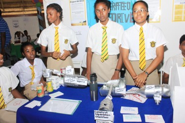 Students of Queen’s College displaying their project ‘Operation oil drive’