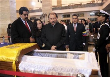 Nicaragua's President Daniel Ortega (C) views the body of late Venezuelan President Hugo Chavez, which is lying in state, as he visits the wake with his wife, Rosario Murillo (2nd L), and Venezuela's Vice-President Nicolas Maduro (L) at the military academy in Caracas March 7, 2013, in this picture provided by the Miraflores Palace. Chavez will be embalmed and put on display "for eternity" at a military museum after a state funeral and an extended period of lying in state, acting President Nicolas Maduro said on Thursday.  REUTERS/Miraflores Palace/Handout 