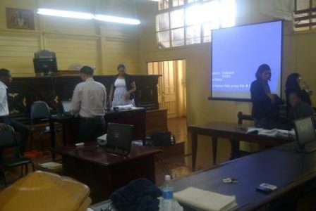 The courtroom for today's hearing. The screen is at right.