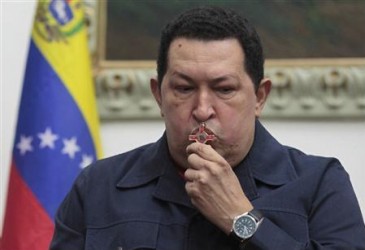 Venezuela's President Hugo Chavez kisses a crucifix as he speaks during a national broadcast at Miraflores Palace in Caracas in this December 8, 2012 file photo.
REUTERS/Miraflores Palace/Handout/Files
