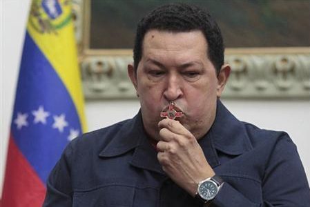Venezuela’s President Hugo Chavez kisses a crucifix as he speaks during a national broadcast at Miraflores Palace in Caracas in this December 8, 2012 file photo.
REUTERS/Miraflores Palace/Handout/Files
