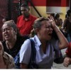 Supporters of Venezuela’s President Hugo Chavez react to the announcement of his death in Caracas, March 5, 2013. REUTERS/Carlos Garcia Rawlins