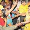 United National Congress (UNC) supporters greet Prime Minister Kamla Persad-Bissessar on her arrival at the party’s Monday Night Forum held at the Carapo RC School, Carapo Main Road in Arima last night. Her husband Dr Gregory Bissessar is on her right. Sport Minister Anil Roberts is behind the Prime Minister. (Trinidad Express photo)