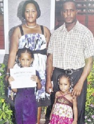 Thirty-two-year-old farmer Rodney Drummond of Content, Adelphi, St James; and 33-year-old hotel worker Tanisha Small of Hopewell, Hanover, with their two daughters Tia (right) and Ranisha Drummond, five and eight respectively. (Jamaica Observer photo) 