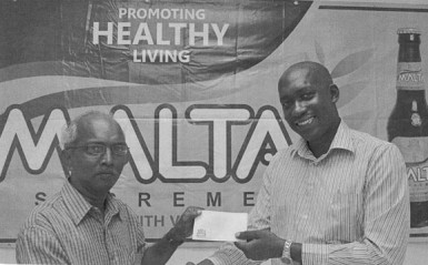 Brand Manager at Banks DIH Clayton McKenzie (right) presents a sponsorship cheque to Secretary of the Guyana Chess Federation Vishnu Rampersaud (left) at Thirst Park. 