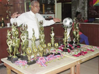 (Linden Town Week): Howell ‘Yellowman’ Hinds stands behind the trophies and medals at the Senior Supervisors Club (SSC), Linden.   