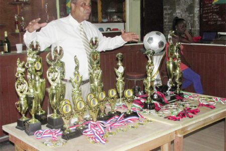 (Linden Town Week): Howell ‘Yellowman’ Hinds stands behind the trophies and medals at the Senior Supervisors Club (SSC), Linden.