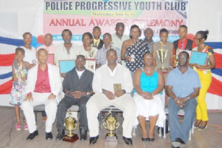 The awardees along with the President of the Athletics Association (AAG) Aubrey Hutson (seated left), President of the youth club Pauline Massay and Colin Boyce Deputy Superintendent of the Guyana Police Force/Games Officer after the Police Progressive Youth Club annual awards ceremony on Friday evening at the Police Sports Club Hall.