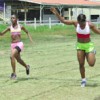 Victory! Leota Babb of Police Progressive Youth Club captures the female 4x100m relay event with a dip at the finish line ahead of Mercury Fast Laner’s Ebony Nelson yesterday afternoon at the Police Sports Club ground, Eve Leary.