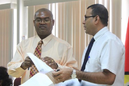 Minister of Natural Resources Robert Persaud (right) and GGMC Acting Commissioner Rickford Vieira at the press conference.