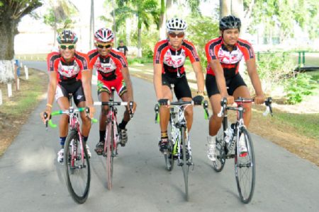 Team Coco’s riders Paul DeNobrega, Raynauth Jeffrey, Raul Leal and Christopher Holder pose for a Stabroek Sport photo before training yesterday. (Orlando Charles photo)