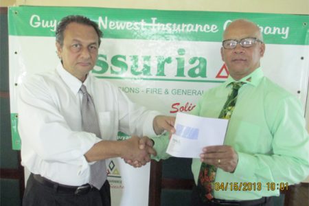 President of the Guyana Boxing Board of Control (GBBC), Peter Abdool (left) accepts the sponsorship cheque from CEO of Assuria Insurance Company, Dick Wesenhagen for Saturday’s mega card dubbed ‘Fire Storm’.
