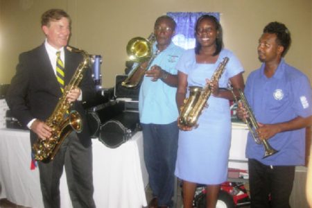 Jazz time: US Ambassador Brent Hardt (left) with Alex Foster (second from left) and Avia Lindie (third from left) as they check out the musical instruments.
