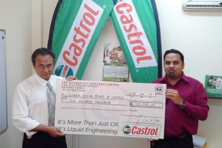 President of the Guyana Boxing Board of Control (GBBC), Peter Abdool (left) accepts the sponsorship cheque from Leonard Khan, Guyoil’s Castrol Brand Manager for Saturday night’s mega card dubbed ‘Fire Storm’. 
 
