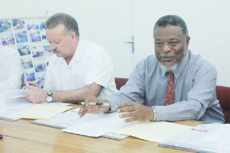 CEO of CM Power company, Rich Munson and Prime Minister Samuel Hinds at the signing of the MOU yesterday.
