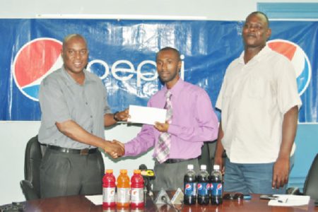Guyana Boxing Association’s (GBA) president, Steve Ninvalle (left) accepts the sponsorship cheque from Brand Executive for Gatorade and Pepsi, Larry Wills to aid in this year’s three under-16 tournaments as GBA’s Technical Director, Terrence Poole looks on. (Orlando Charles photo)