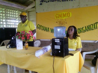 GWMO President Simona Broomes (left) along with another member of the organisation addressing residents at Port Kaituma on Friday. 