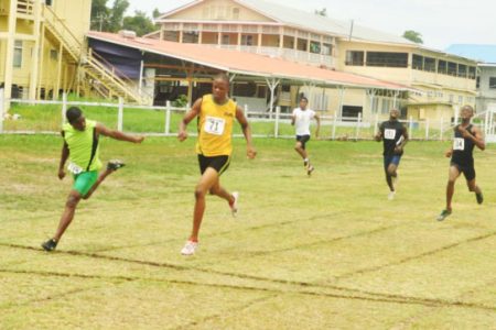 STILL ON TOP! Tevin Garraway dips on the line in the Junior boys’ 200m finals ahead of CARIFTA Games bronze medalist, Jason Yaw to retain his title clocking 21.8 seconds yesterday afternoon at the Police Sports Club ground, Eve Leary.
