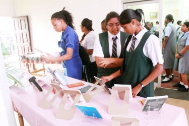Oh for a book… Students of the Bishops’ High School pouring over the display at an exhibition to mark World Book and Copyright Day at the National Library yesterday. (Photo by Arian Browne)