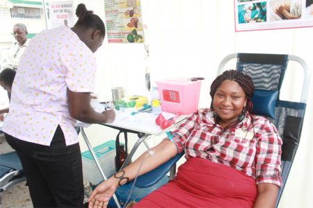 An employee of GRA donating blood yesterday. (Photo by Arian Browne)
