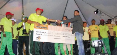 Terrence Sukhu (right, front) hands cheque over to Wolf’s Warriors skipper while team members, supporters and sponsors’ representatives look on