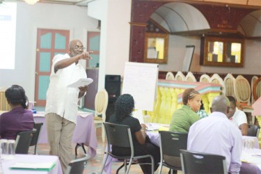 Social worker Michael Fraser (standing) making a point during his presentation at the workshop that was held to coordinate law enforcement officers and social workers in establishing “one-stop” centres for abused children.