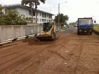 Shells deposited by the waves in the vicinity of the Russian Embassy being removed