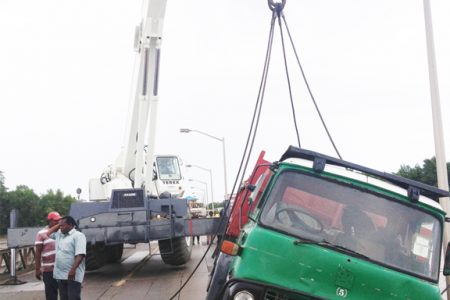 The truck being lifted by a crane from John Fernandes Limited.
