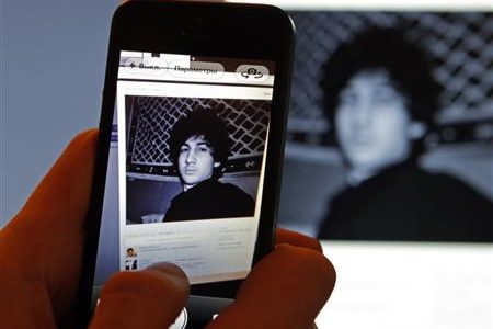 A photograph of Djohar Tsarnaev, who is believed to be Dzhokhar Tsarnaev, a suspect in the Boston Marathon bombing, is seen on his page of Russian social networking site Vkontakte (VK), as pictured on a monitor and a mobile phone in St. Petersburg April 19, 2013.
Credit: Reuters/Alexander Demianchuk
