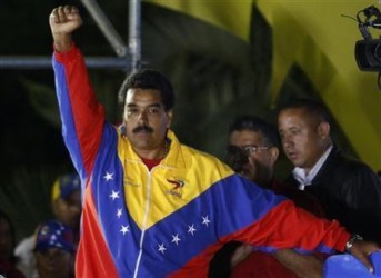 Venezuelan presidential candidate Nicolas Maduro celebrates after the official results gave him a victory in the balloting, in Caracas April 14, 2013.
REUTERS/Tomas Bravo