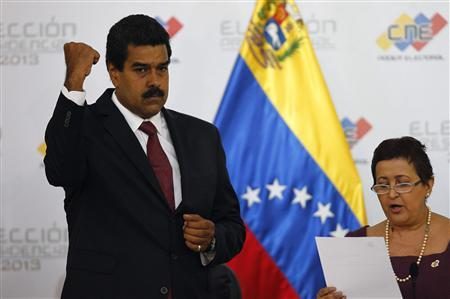 
Venezuela's President-elect Nicolas Maduro gestures as Tibisay Lucena, president of the National Electoral Council (CNE), reads a certificate confirming him as winner of Sunday's election, in Caracas, April 15, 2013.Credit: Reuters/Carlos Garcia Rawlins
