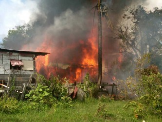 The house on fire after the plane crashed into it.