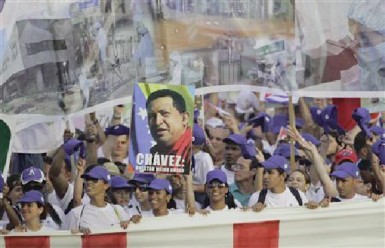 People carry a poster of late Venezuelan leader Hugo Chavez during the Mayday parade in Havana’s Revolution Square May 1, 2013.  (Reuters/Desmond Boylan)