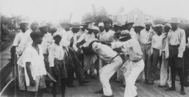 Drummer and dancers at the Baghwat Festival, Port Mourant, 1938