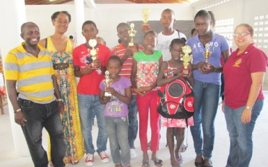 The winners of the Buxton literacy programme spelling B competition with at extreme left, founder of the project Robin Phillips and at far right, President of the Rotary Club of Stabroek Luana Falconer. 