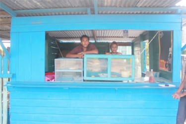 Bibi and her son Avinash inside her food shop