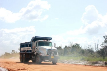 One of the company’s trucks taking laterite to its Demerara River front location at Bamia.  