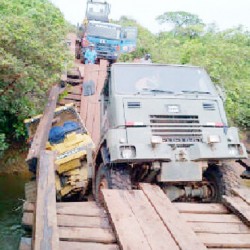 The broken bridge and the stalled trucks