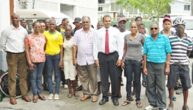 Minister of Culture, Youth and Sports, Dr. Frank Anthony along with Permanent Secretary Alfred King, cyclists and national cycling Coach Hassan Mohamed pose for a photo opportunity at the sports ministry after the official send off of the cyclists for the 31st annual three-stage race. (Orlando Charles photo) 