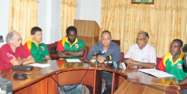 Director of Sport, Neil Kumar makes a point at yesterday’s press briefing ahead of today’s rubgy match versus Barbados as National Captain and Coach, Ryan Gonsalves and Theodore Henry and the GRFU’s top brass look on. (Orlando Charles photo)  